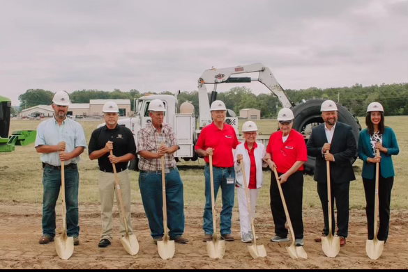 The owners and all those involved in the expansion grab their shovels and smile for the official groundbreaking. 
