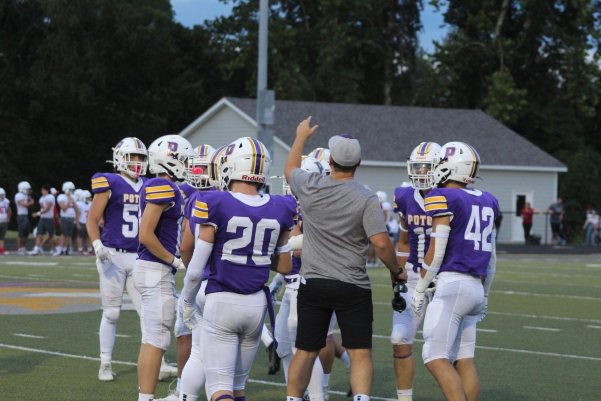 Coach Wyrick on the field making sure his players know what play they are going to be running.