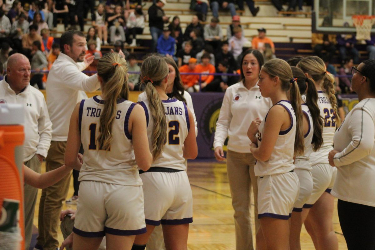 The girls huddle up to talk about game play.