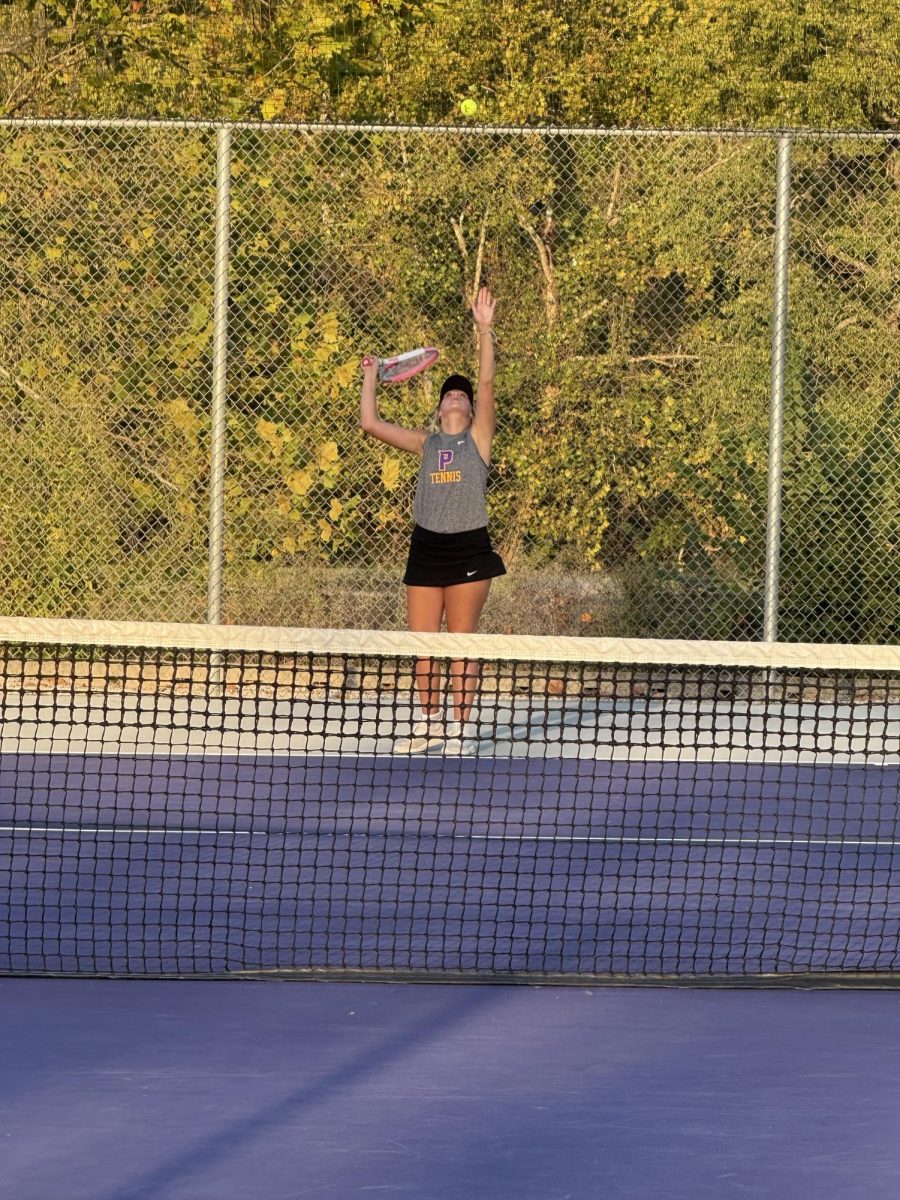 Senior Emily Brewer serves for a point to win her first singles match.